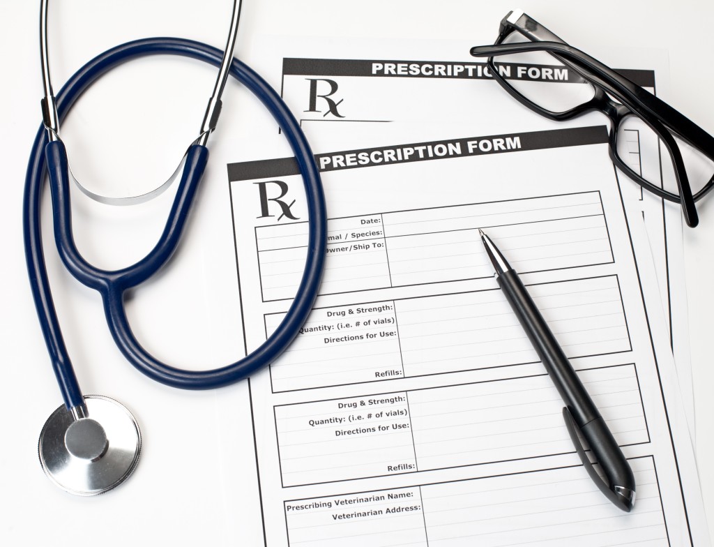 Blank veterinarian prescription form with stethoscope glasses and pen