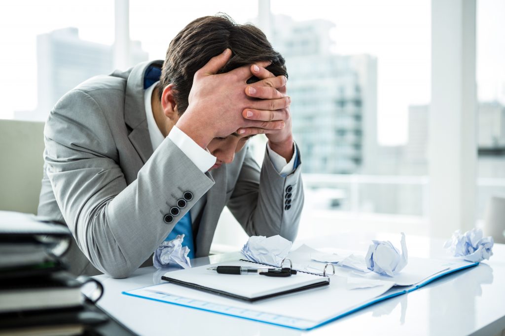 Businessman being depressed by working in office