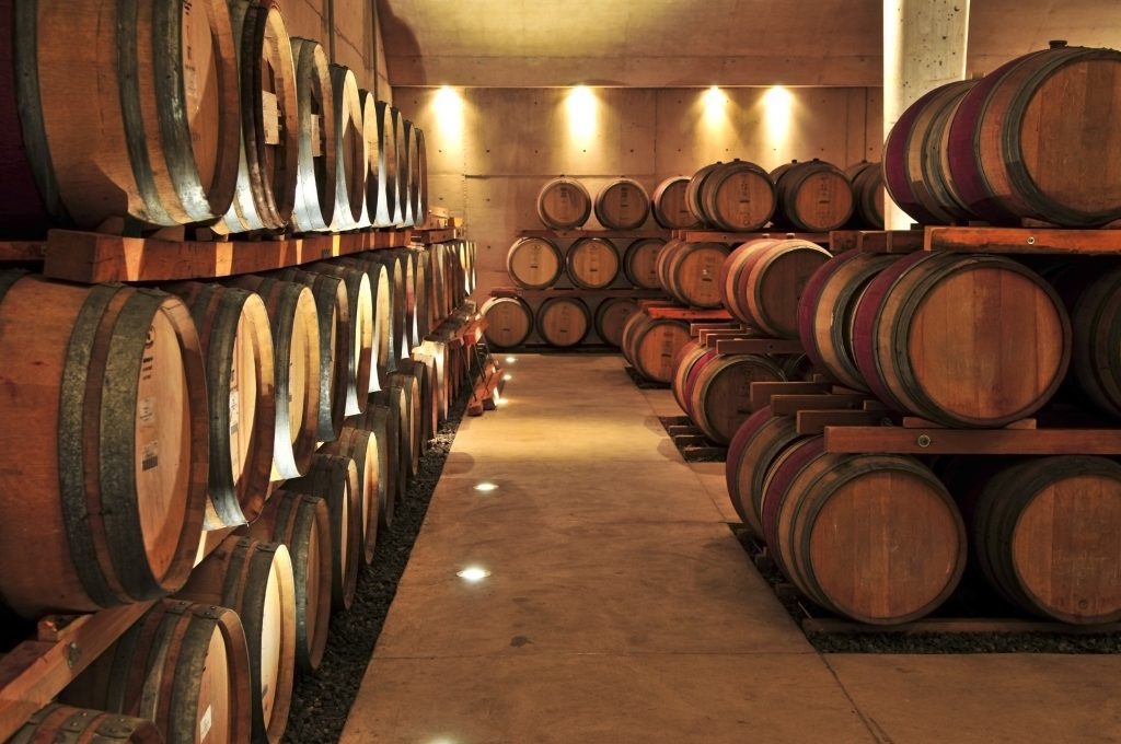 Stacked oak wine barrels in winery cellar
