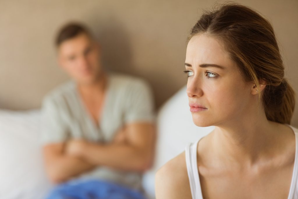 Upset couple not talking to each other after fight at home in the bedroom